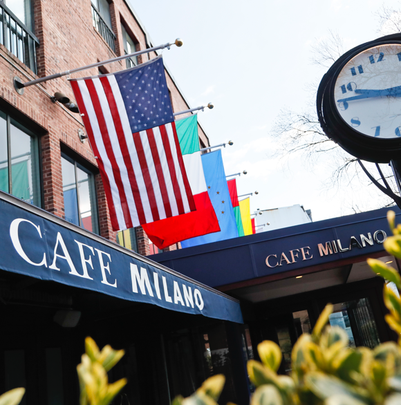 Cafe Milano exterior with multiple international flags